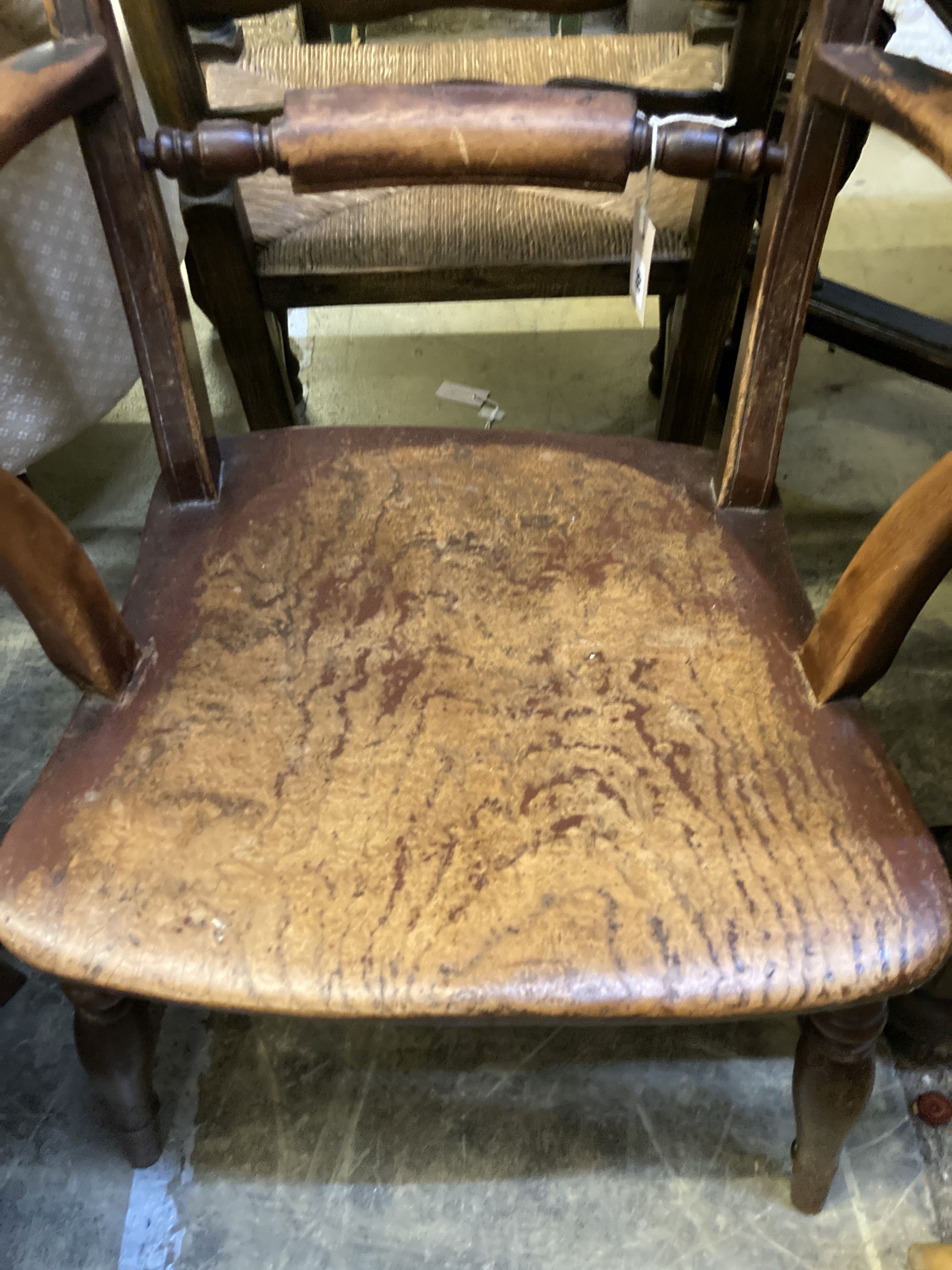 A 19th century ash and beech ladderback elbow chair and a spindle back elbow chair (2)